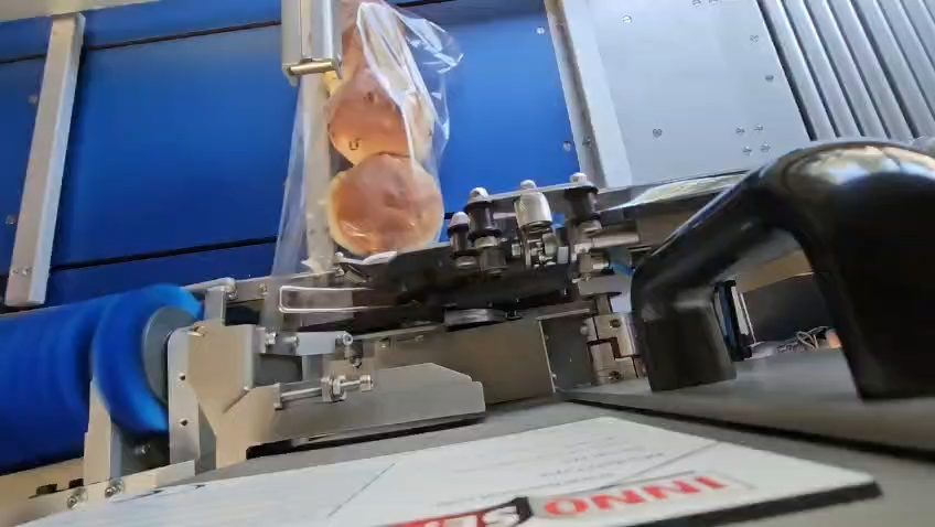 The Innomatic closing bags on a production line