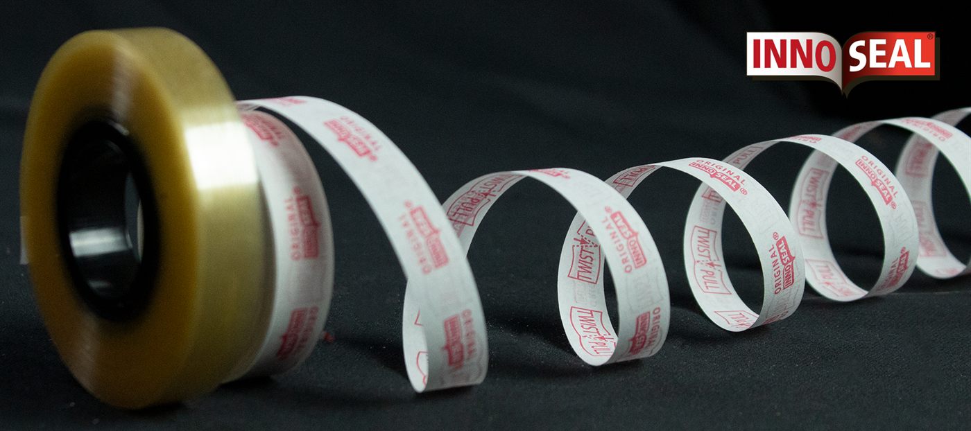 A roll of Innoseal tape with the paper strip spiralling out, TWIST PULL printed along it