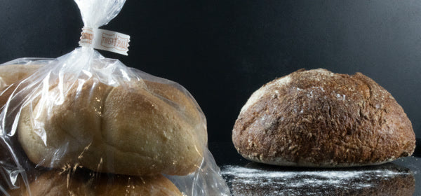 A bag of bread rolls closed with an Innoseal TWIST PULL closure, beside a fresh loaf